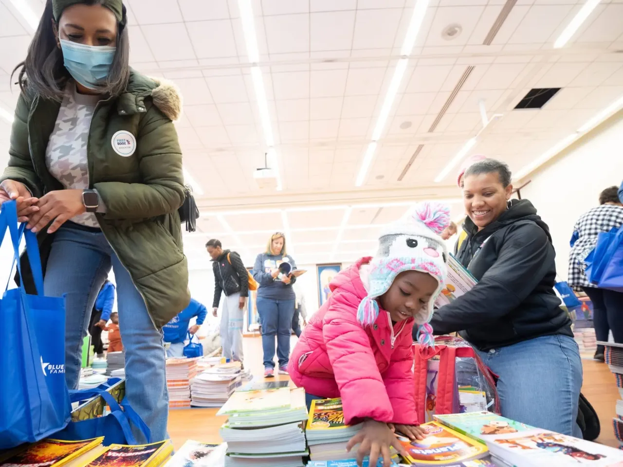 First Book volunteers distributing books to children and families